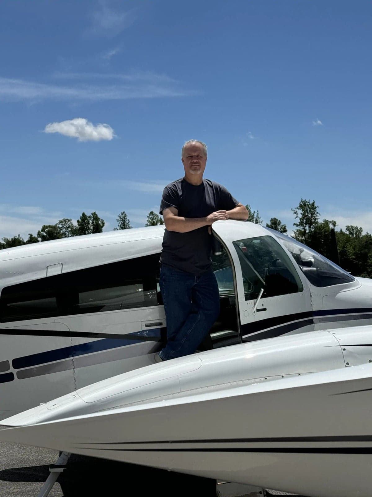 Man standing on the wing of the aircraft.
