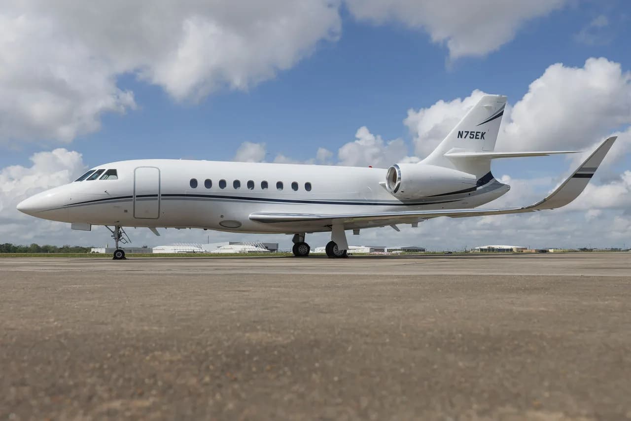 Side view of a white jet with registration N75EK on the tail.