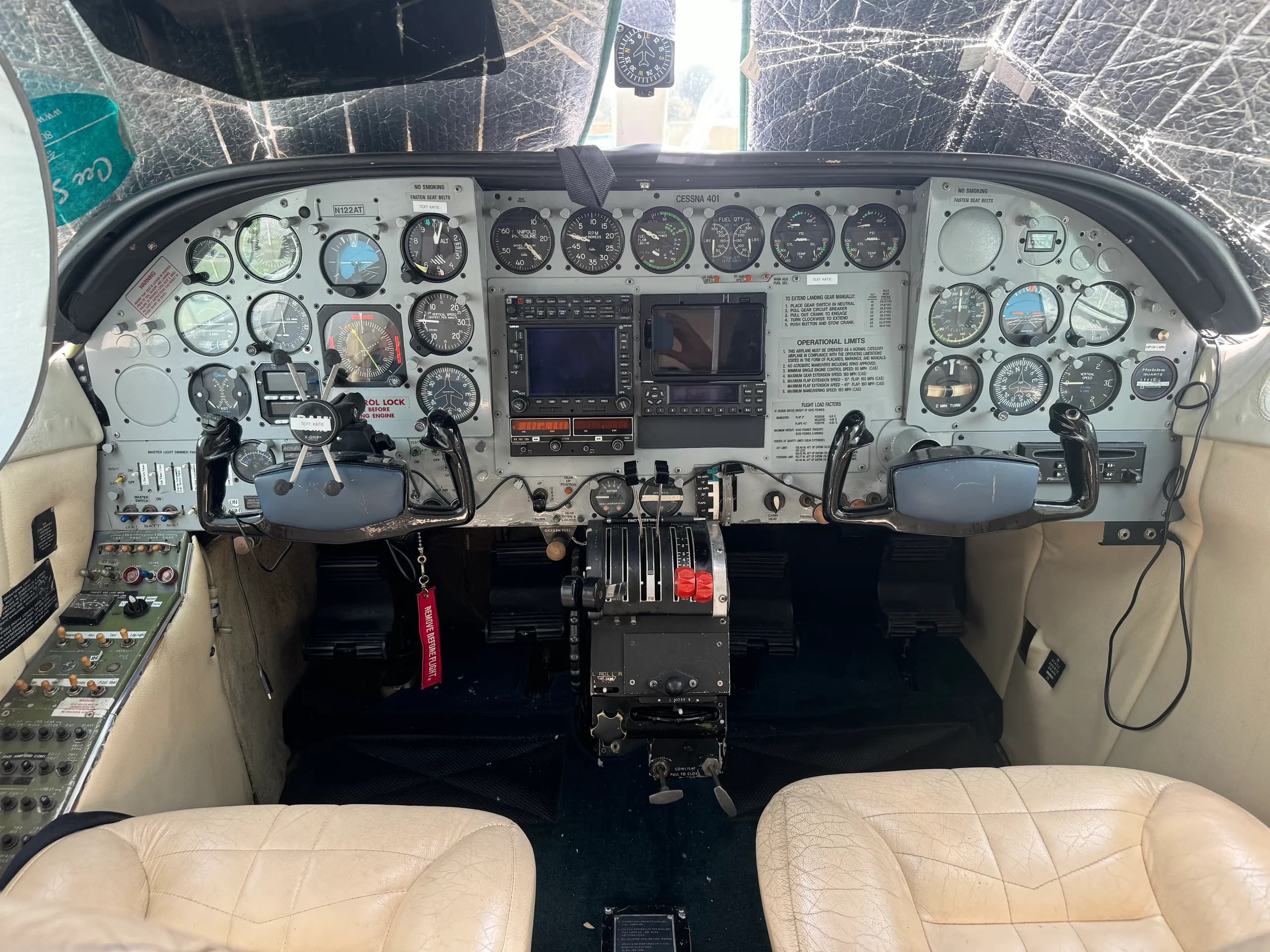 The cockpit of a Cessna 401 aircraft, showing the instrument panel, yokes, and center console.