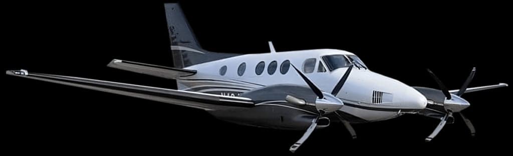 A King Air aircraft in a white and gray paint scheme against a black background.