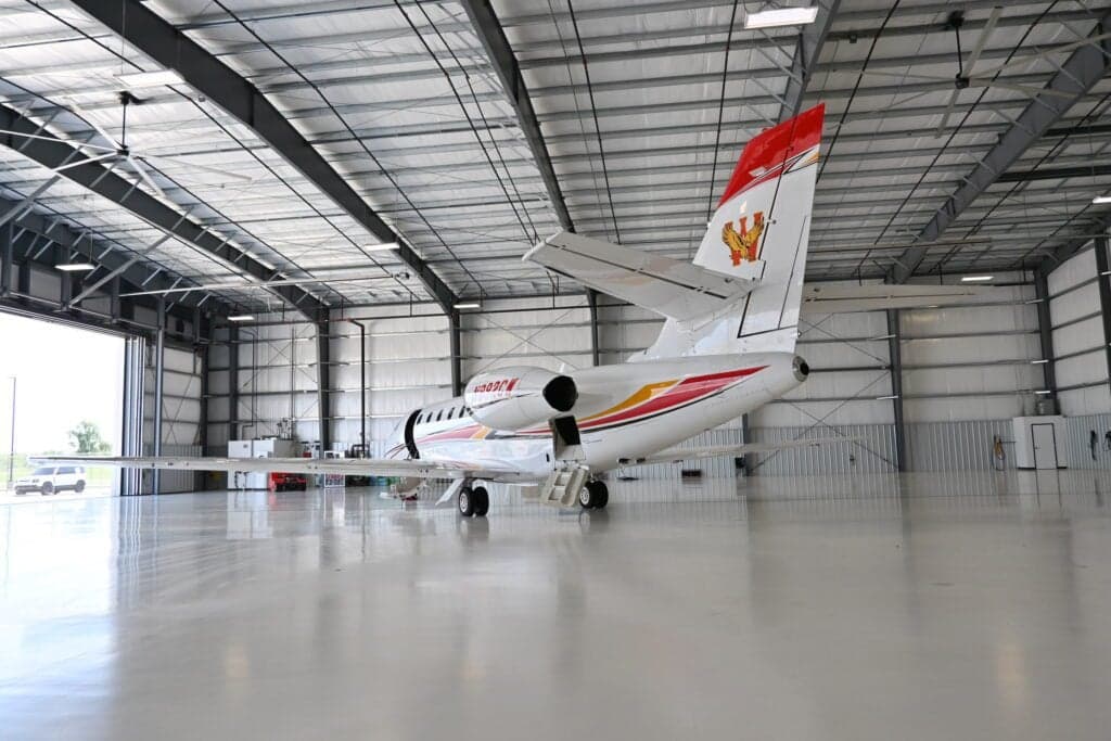 Rear quarter view of a Citation Sovereign aircraft with tail number N892CW in a hangar.