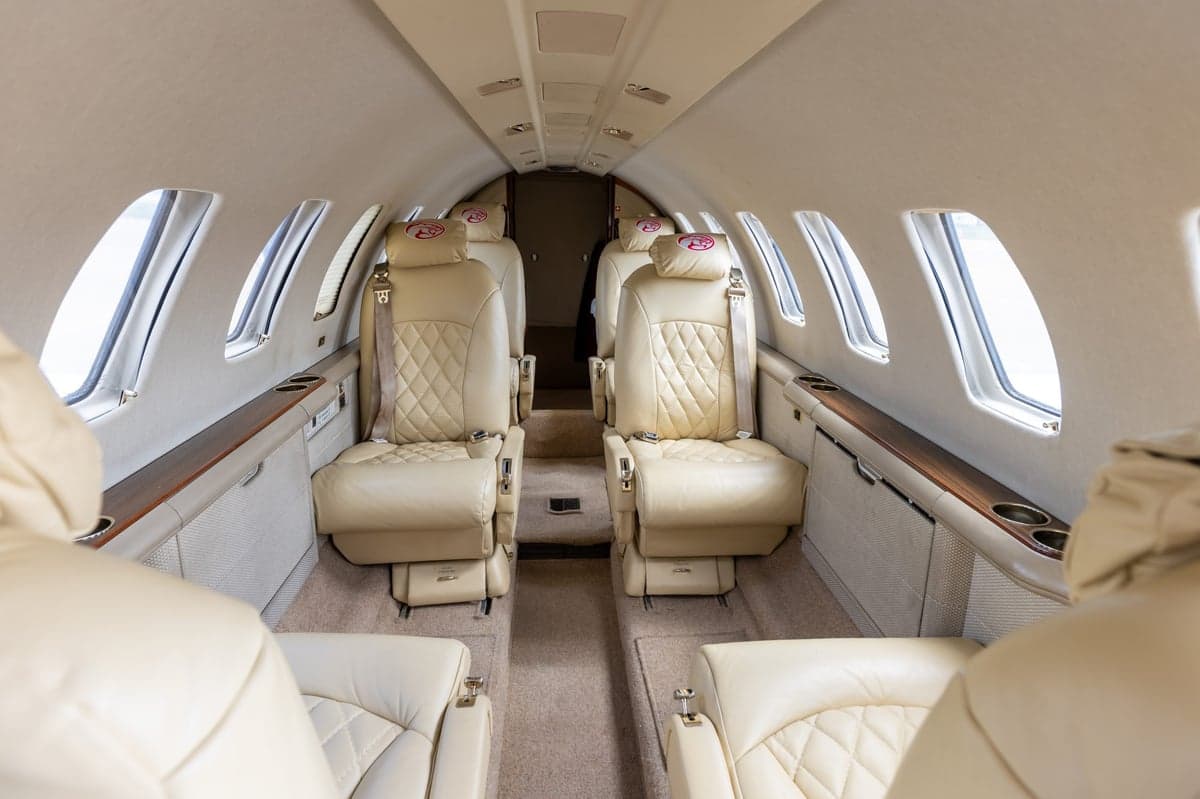 The interior of a Cessna Citation CJ3 with cream leather seats.