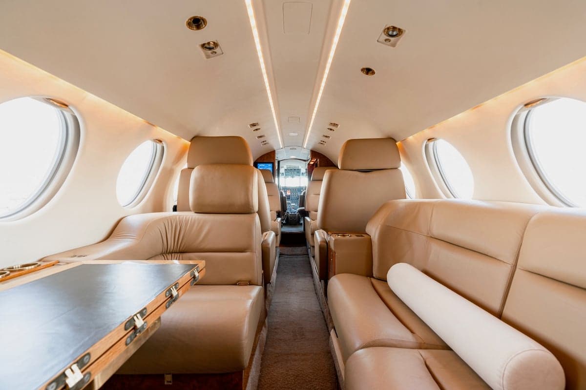 A view of the interior of a Falcon 50 aircraft, showing the seating arrangement and cabin details.