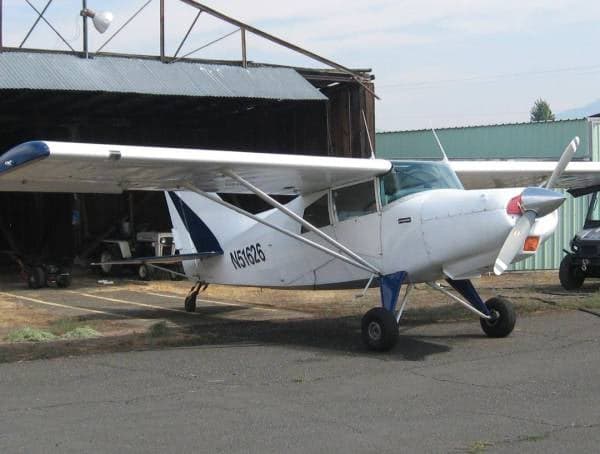 A white and blue Maule M-5-235C, registration N51626, parked near a hangar.