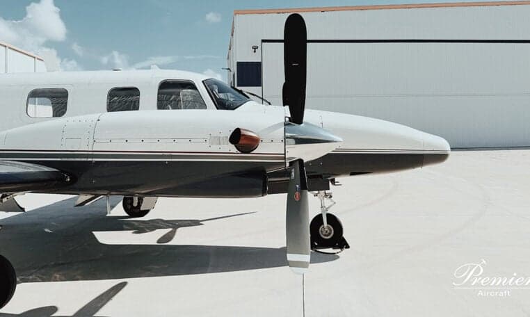 Close-up of the propeller and nose of a twin-engine aircraft.