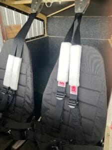 Close-up of the black seats with white padding in the aircraft's interior.