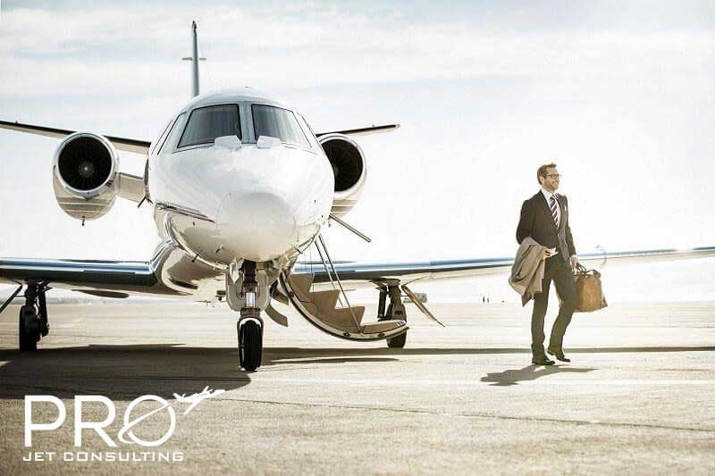 Stock photo of a business jet with a man walking towards it.
