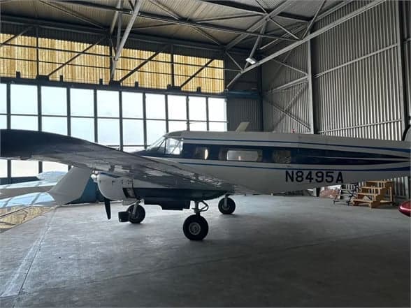 Front view of a Beechcraft Model 18 with registration N8495A on the tarmac.