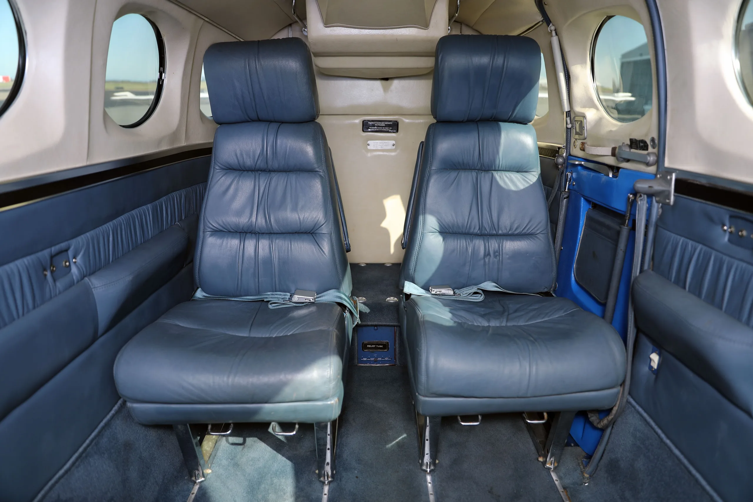 Two dark blue leather passenger seats in the cabin of the Cessna 340.