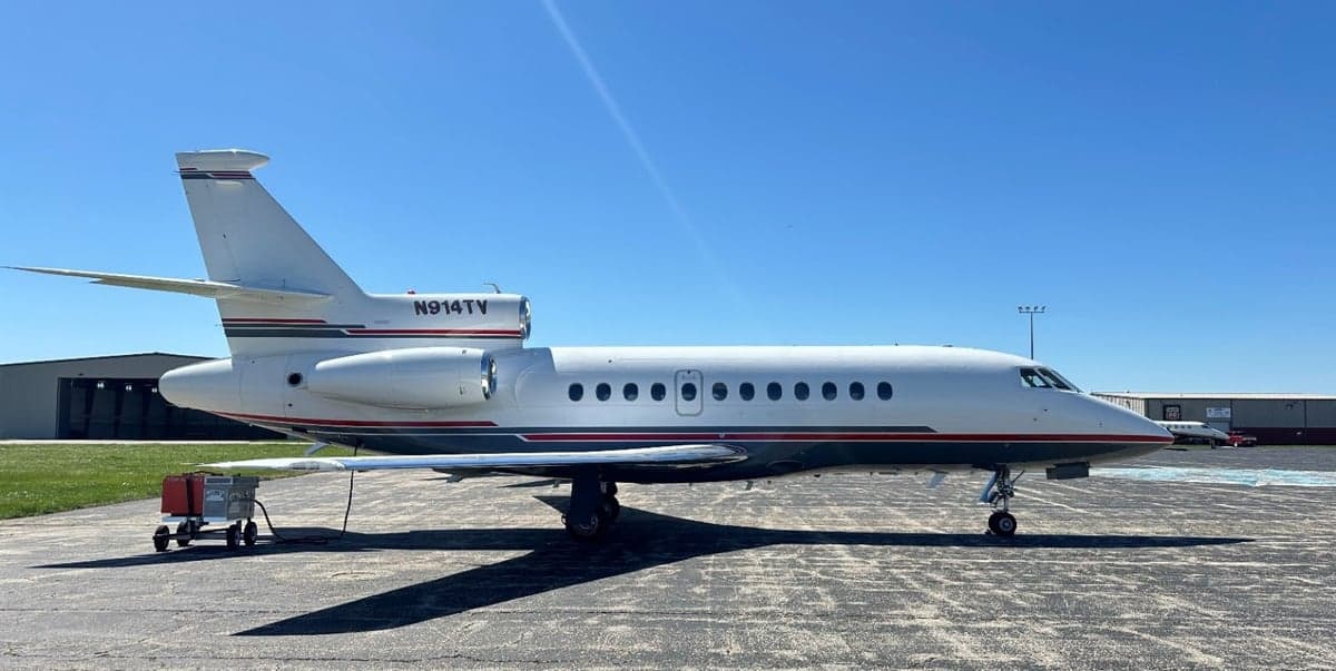 Side view of the N914TV aircraft parked on the tarmac.