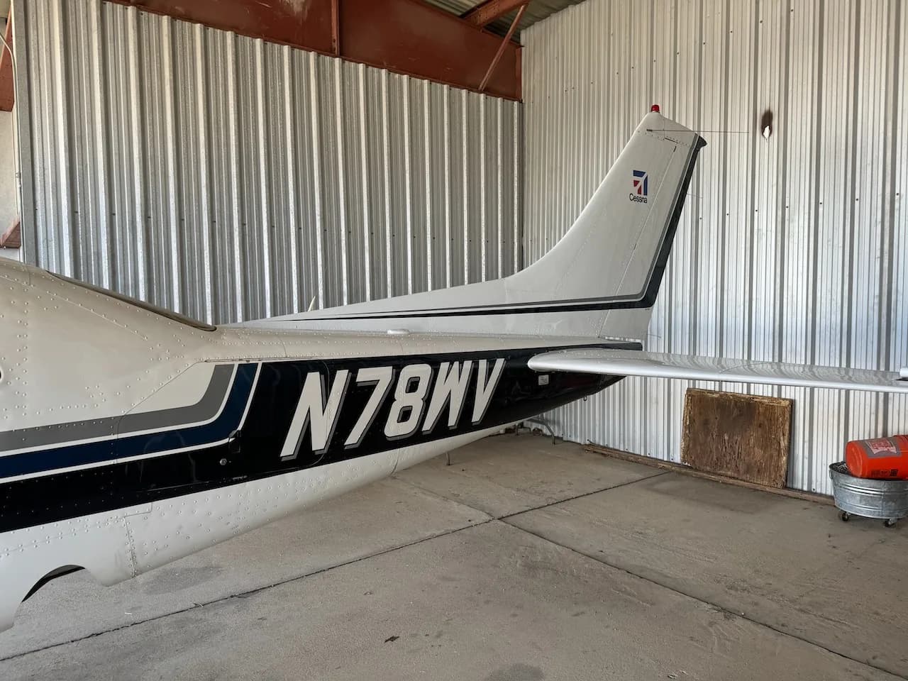 A close-up view of the tail section of a white Cessna aircraft, showing registration N78WV and the Cessna logo.