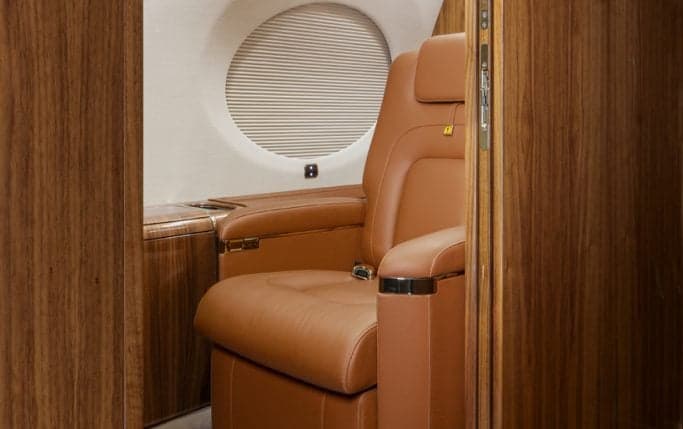 The aircraft's cockpit features multiple display screens and controls.