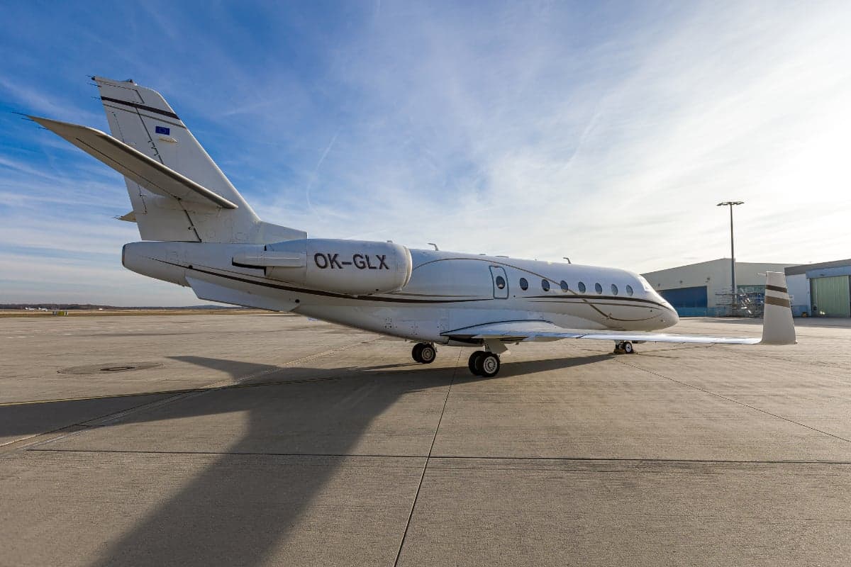 Gulfstream G200 aircraft with the tail number OK-GLX parked on the tarmac.