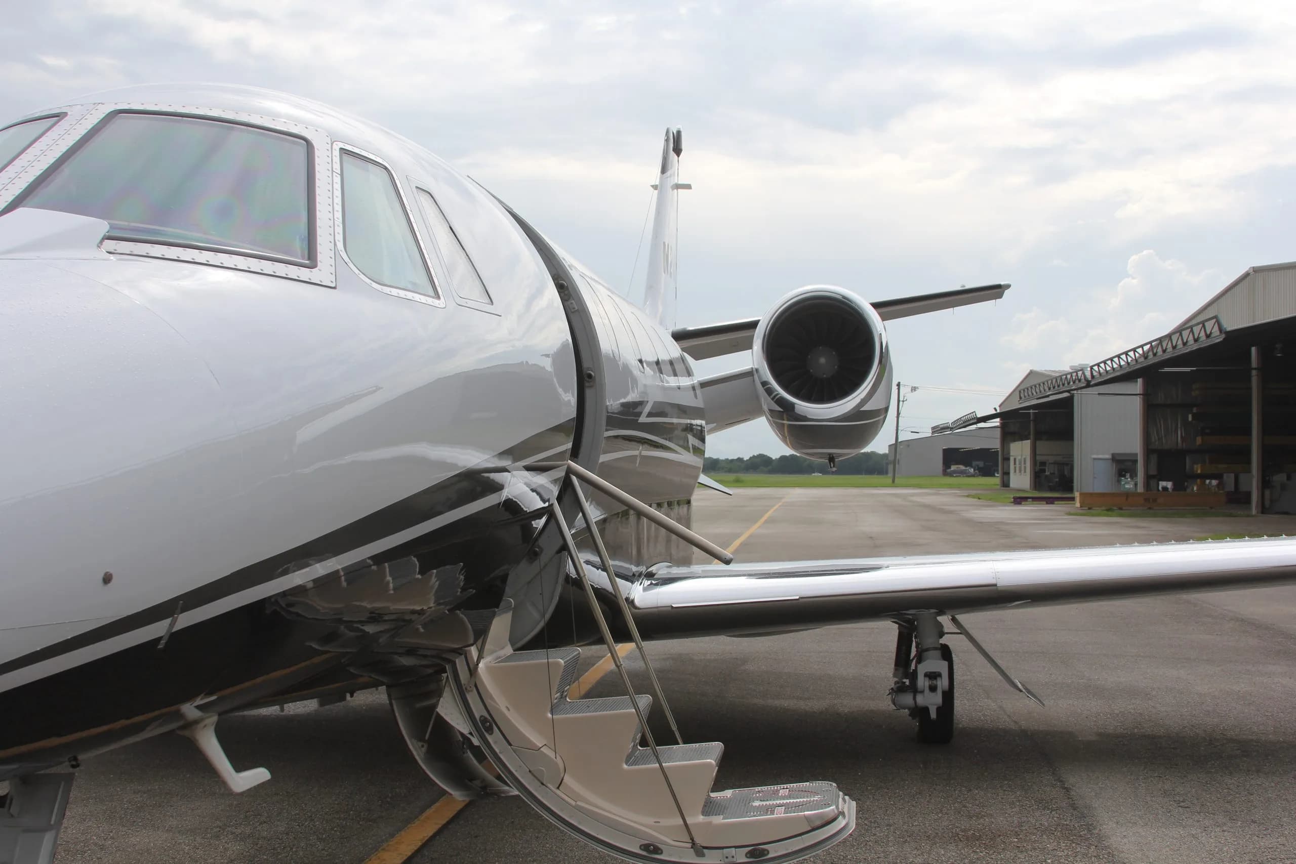 Close-up of the N283MM aircraft entrance and engine.