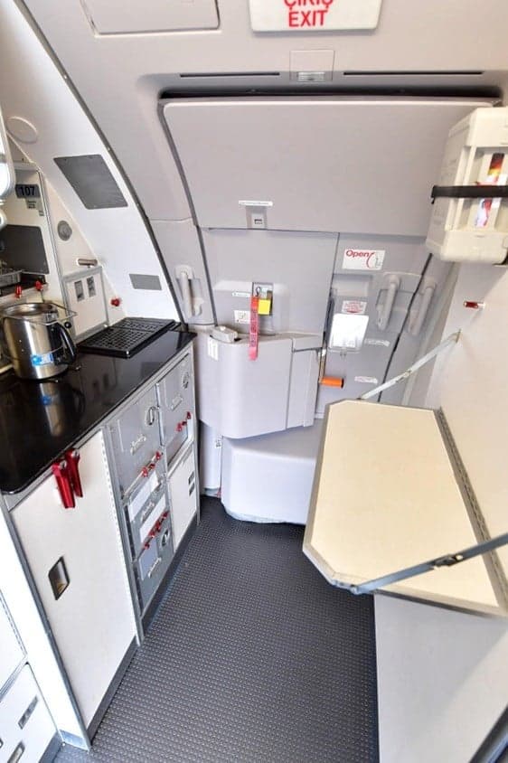 Galley area with exit sign inside the aircraft.