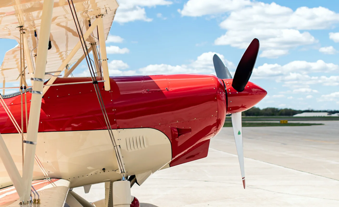 Close up of the red and white biplane's engine and propeller.