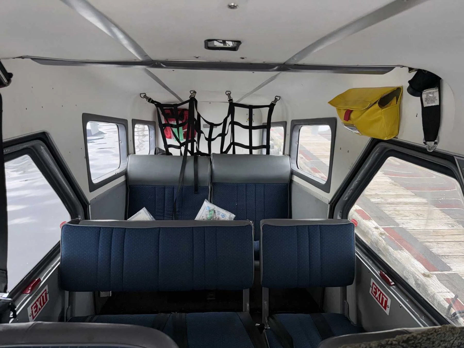 View of the rear passenger seats inside the aircraft cabin.