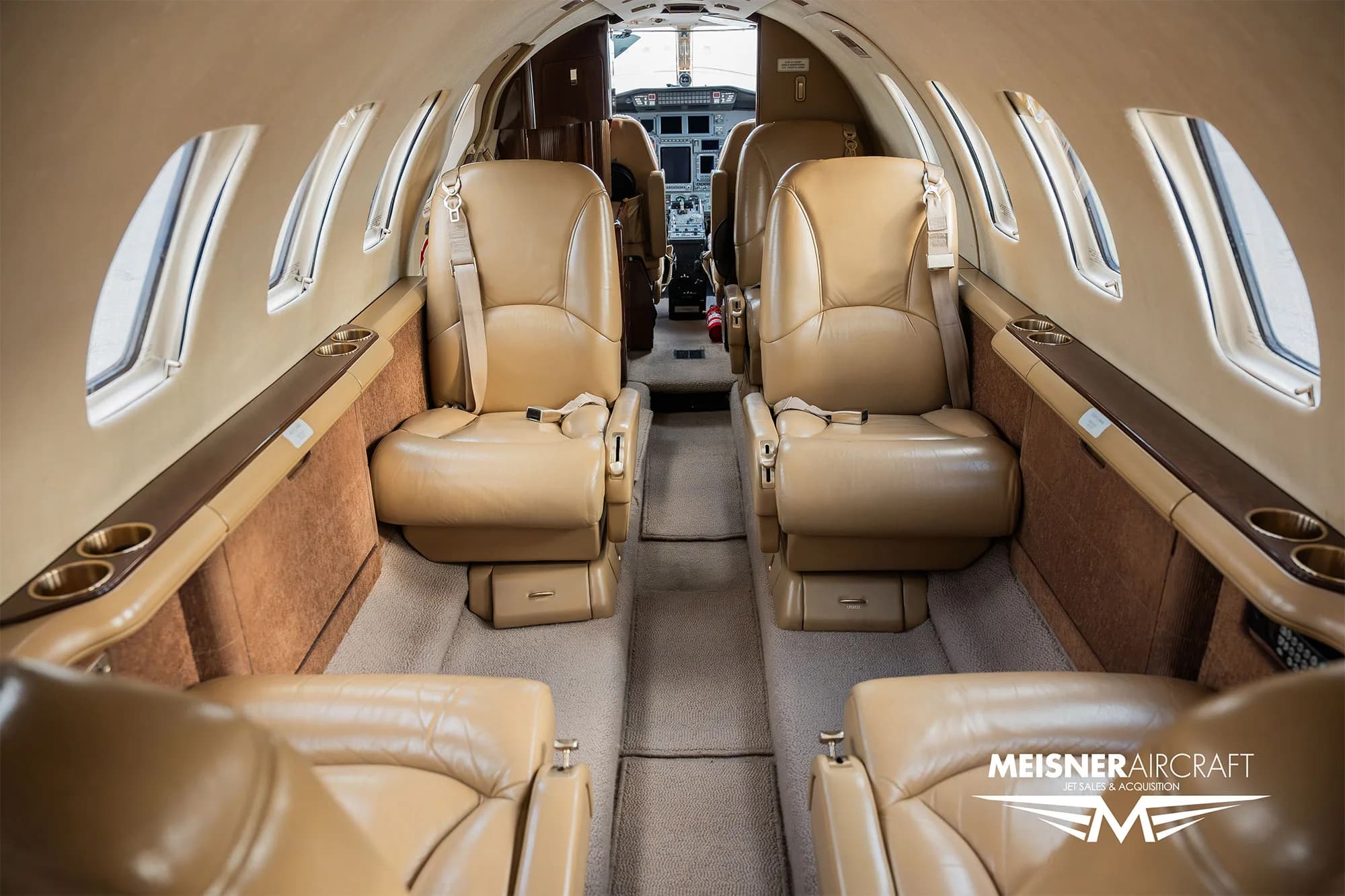 Interior view of a Cessna Citation Encore with tan leather seats.
