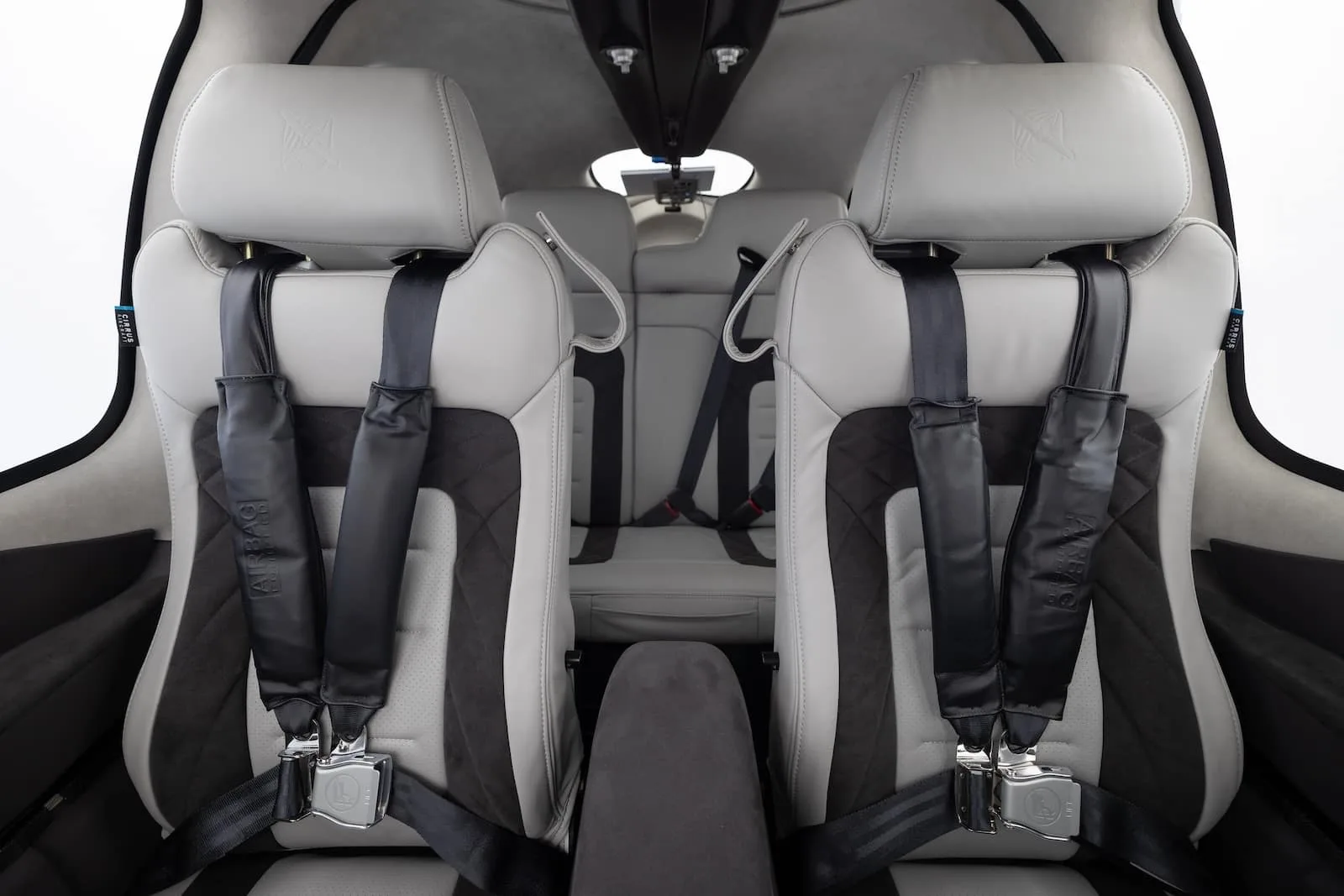 The interior of a Cirrus aircraft features comfortable seating with black and gray accents.