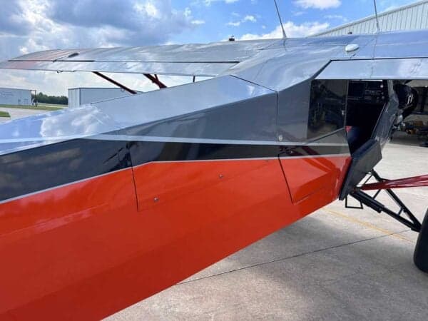 Close-up of the aircraft's fuselage with an open door.
