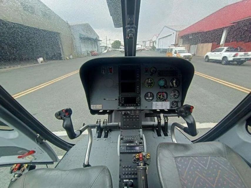 View of the helicopter cockpit from the pilot's seat.
