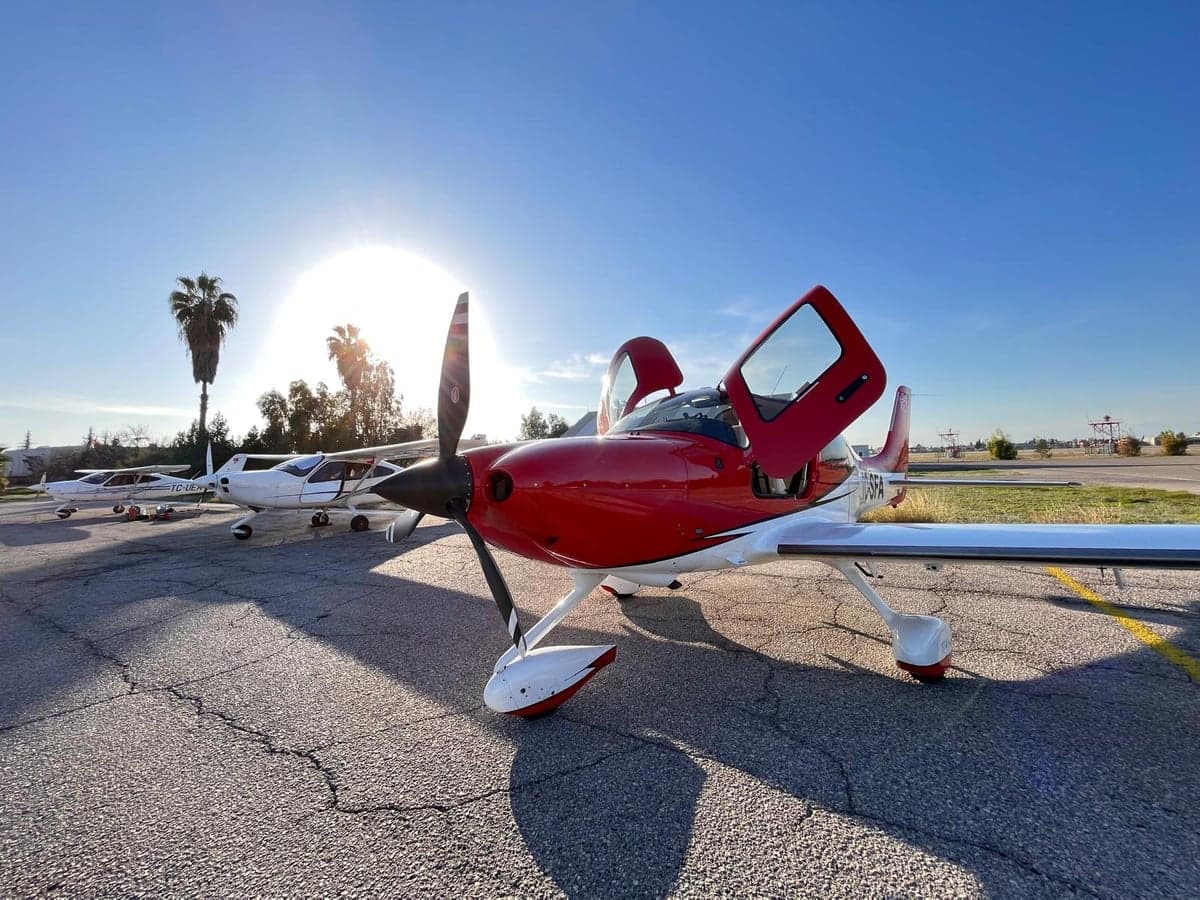 TC-SFA aircraft with red and white paint scheme on the tarmac.
