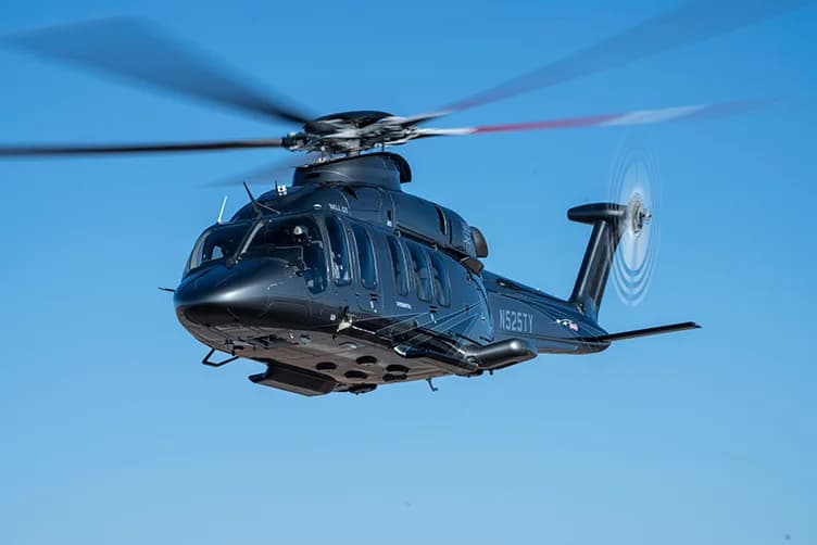 A black Bell 525 helicopter in flight.