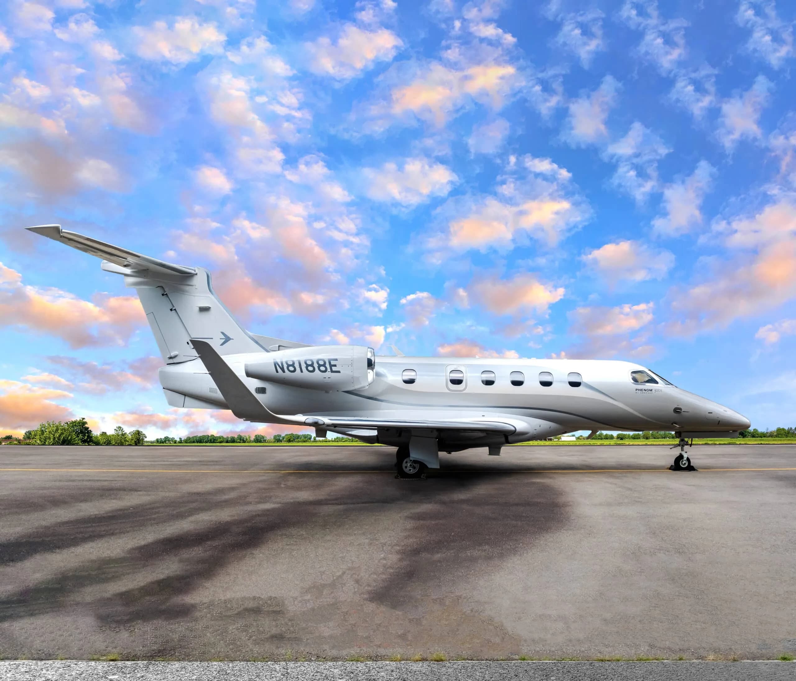 Phenom 300E aircraft with registration N8188E on the tarmac.