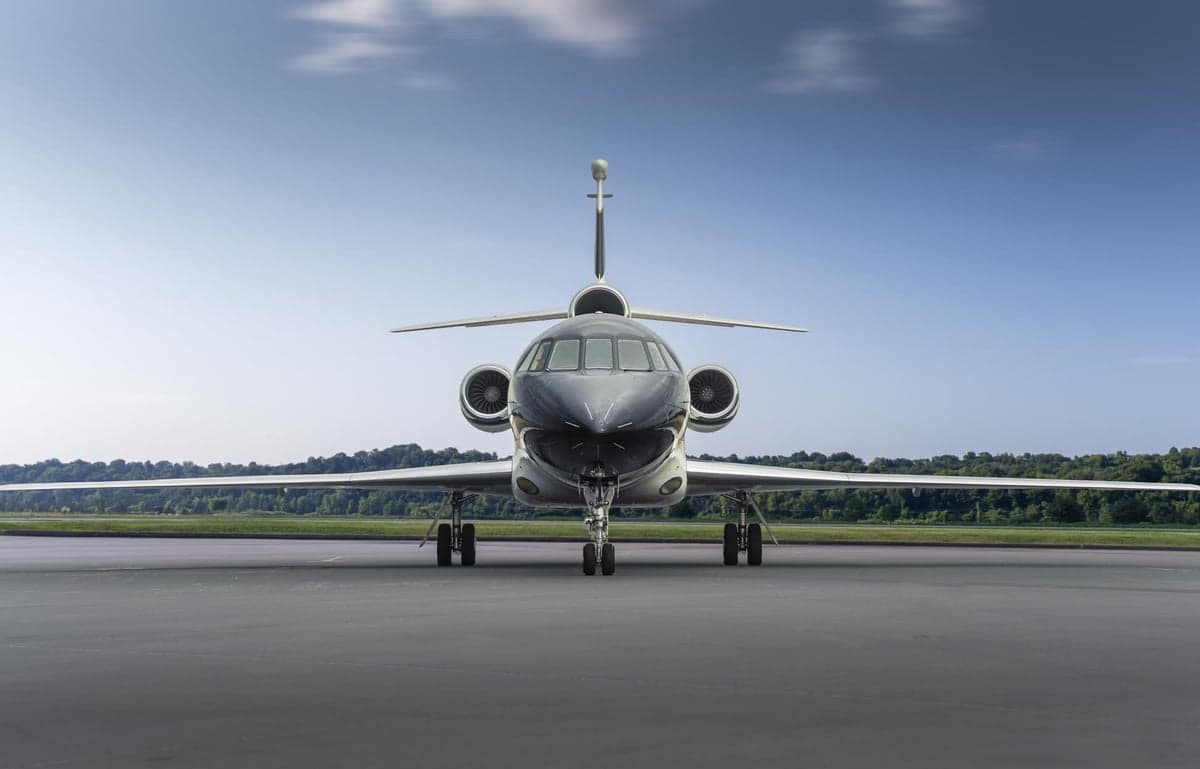 Front view of a Falcon aircraft with registration N608LC on the tarmac.