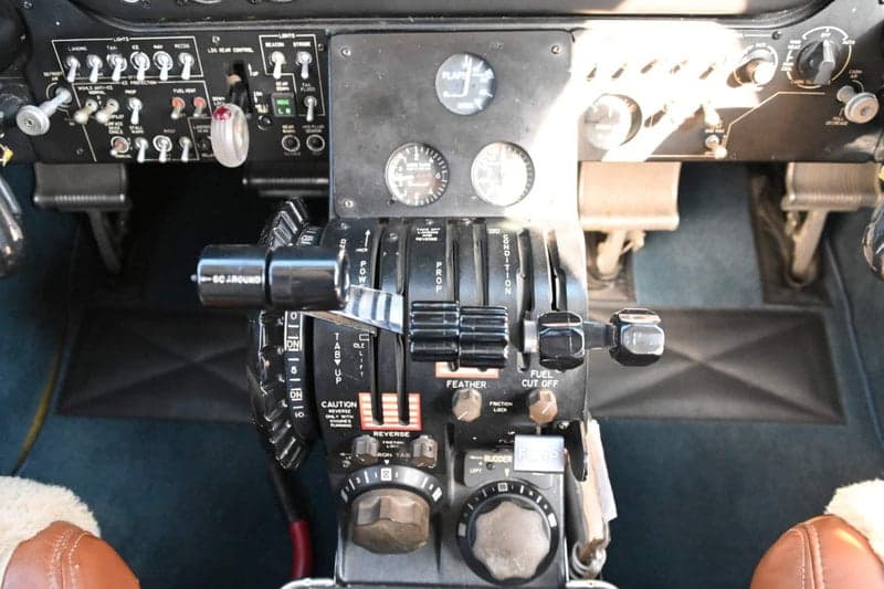 Close up of the throttle quadrant and other controls in the cockpit of a Beechcraft King Air.