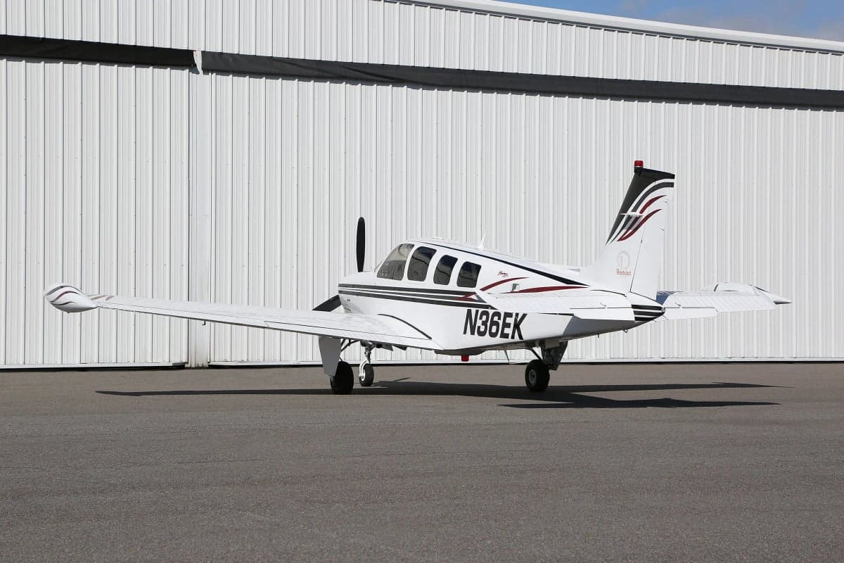 Side view of a Beechcraft Bonanza on the tarmac with registration number N36EK.