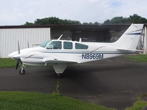 Beechcraft Bonanza N8969M parked on the tarmac.