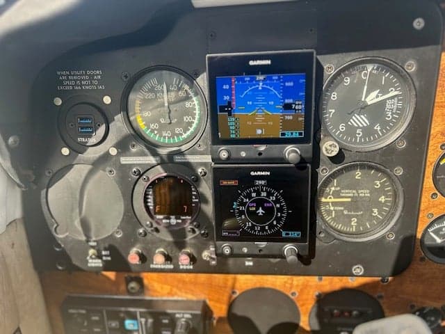 Close-up of the aircraft's instrument panel with Garmin displays and gauges.
