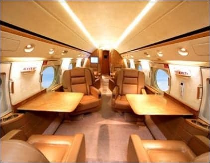 Interior view of the Gulfstream cabin with leather seats and tables.