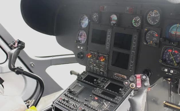Close-up of the helicopter's instrument panel and controls.