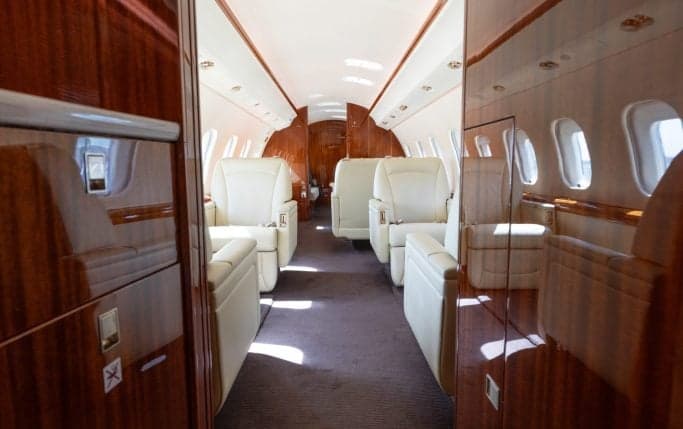 Aircraft lavatory with marble countertop and two sinks.