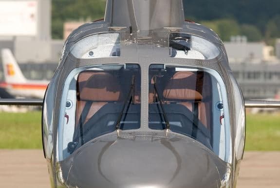 A close-up view of the helicopter's cockpit through the windshield.
