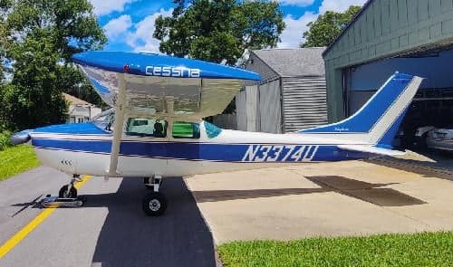 A side view of the Cessna 172 Skyhawk, registration N3374U, showing its blue and white paint scheme.