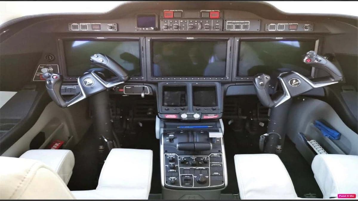The cockpit of the aircraft features multiple display screens and controls.