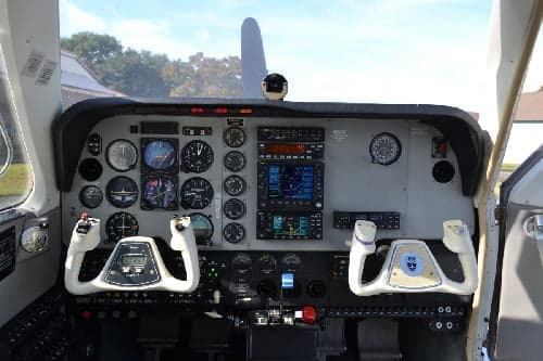 The instrument panel of an aircraft cockpit with various gauges and controls.