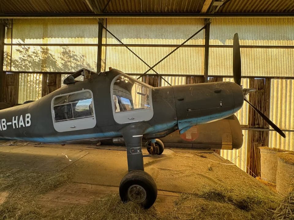 Low angle view of the HB-HAB aircraft propeller and nose inside a hangar.