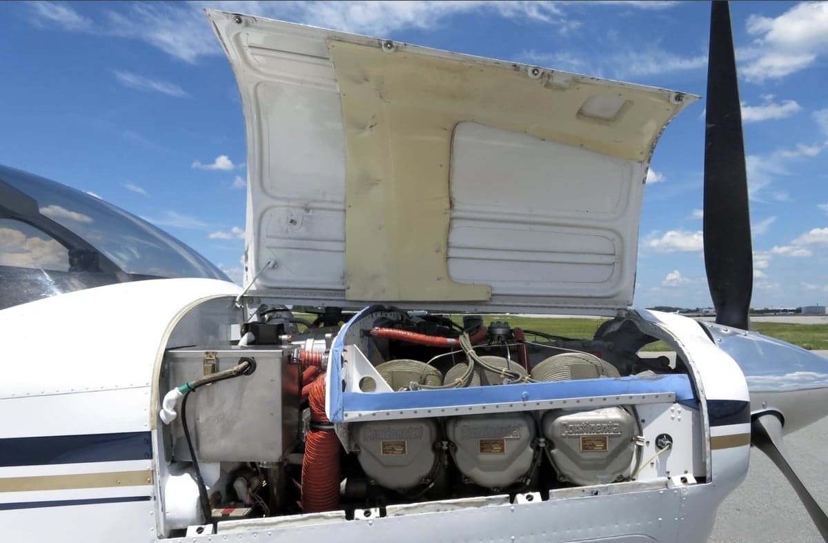 View of the engine compartment of the Beechcraft Bonanza N428TL with the cowling open.