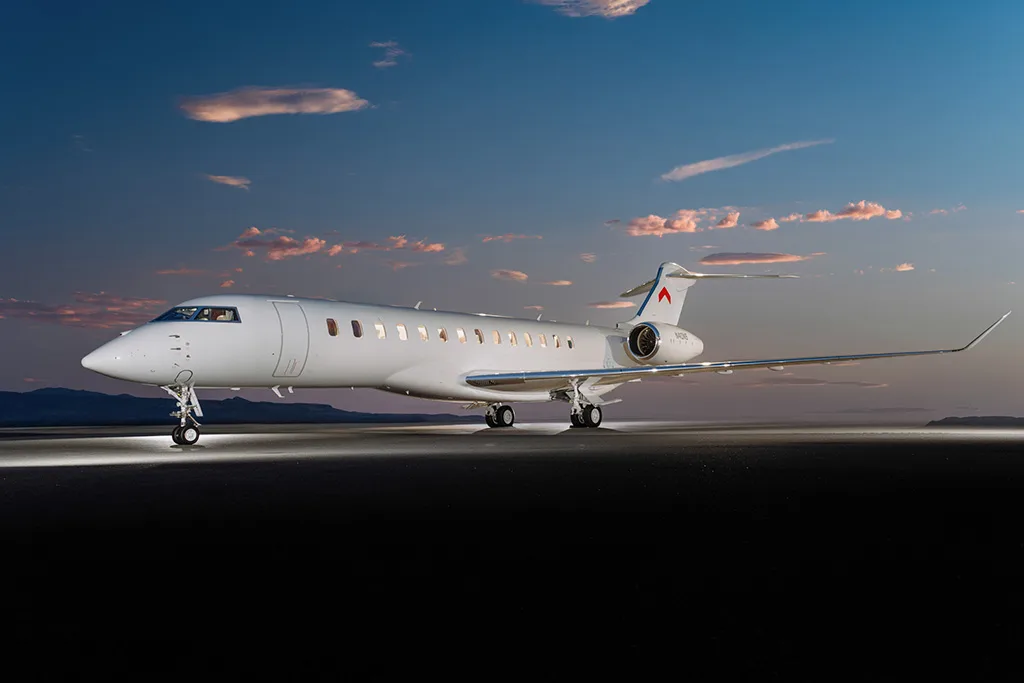 A white Bombardier Global 7500 business jet, tail number N40NS, parked on a tarmac at sunset.