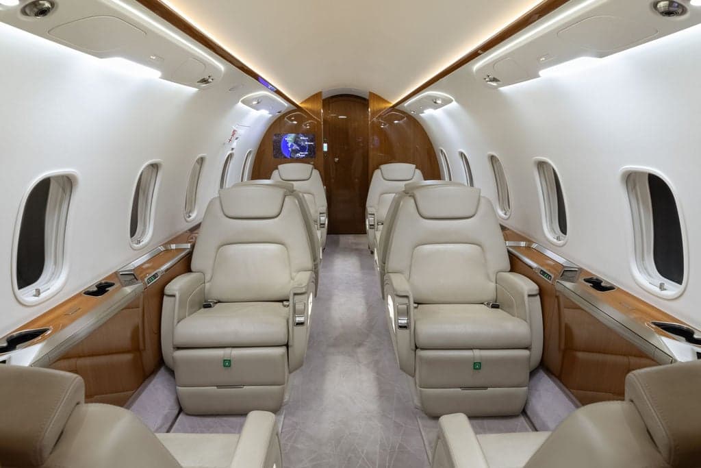 View of the aircraft's interior with cream-colored leather seats.