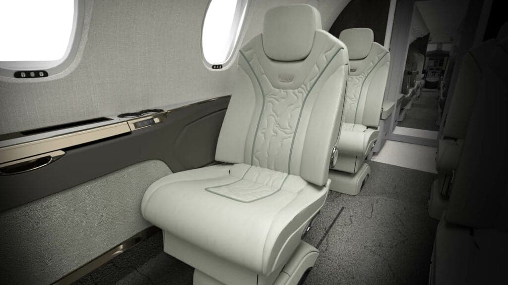 Close-up of a white leather aircraft seat.