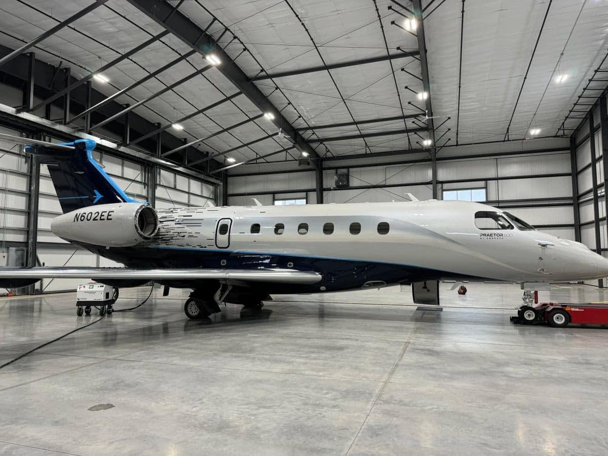 N602EE Praetor 600 aircraft in a hangar, side view.