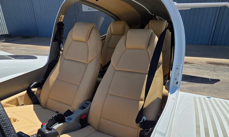 Interior view of the Diamond DA62 aircraft cabin with tan leather seats.