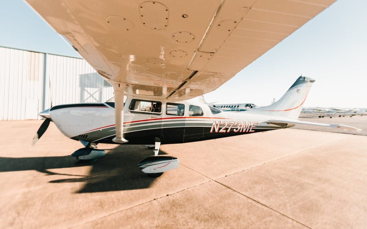 Low angle side view of Cessna 206 Turbo Stationair TC aircraft N273ME on the ground.