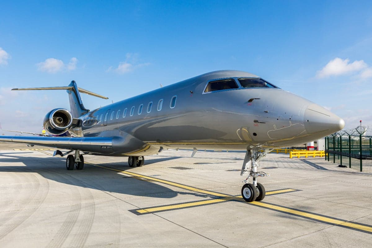The Bombardier Global 5000 aircraft 9H-ARE is parked on the tarmac with a gray paint scheme.