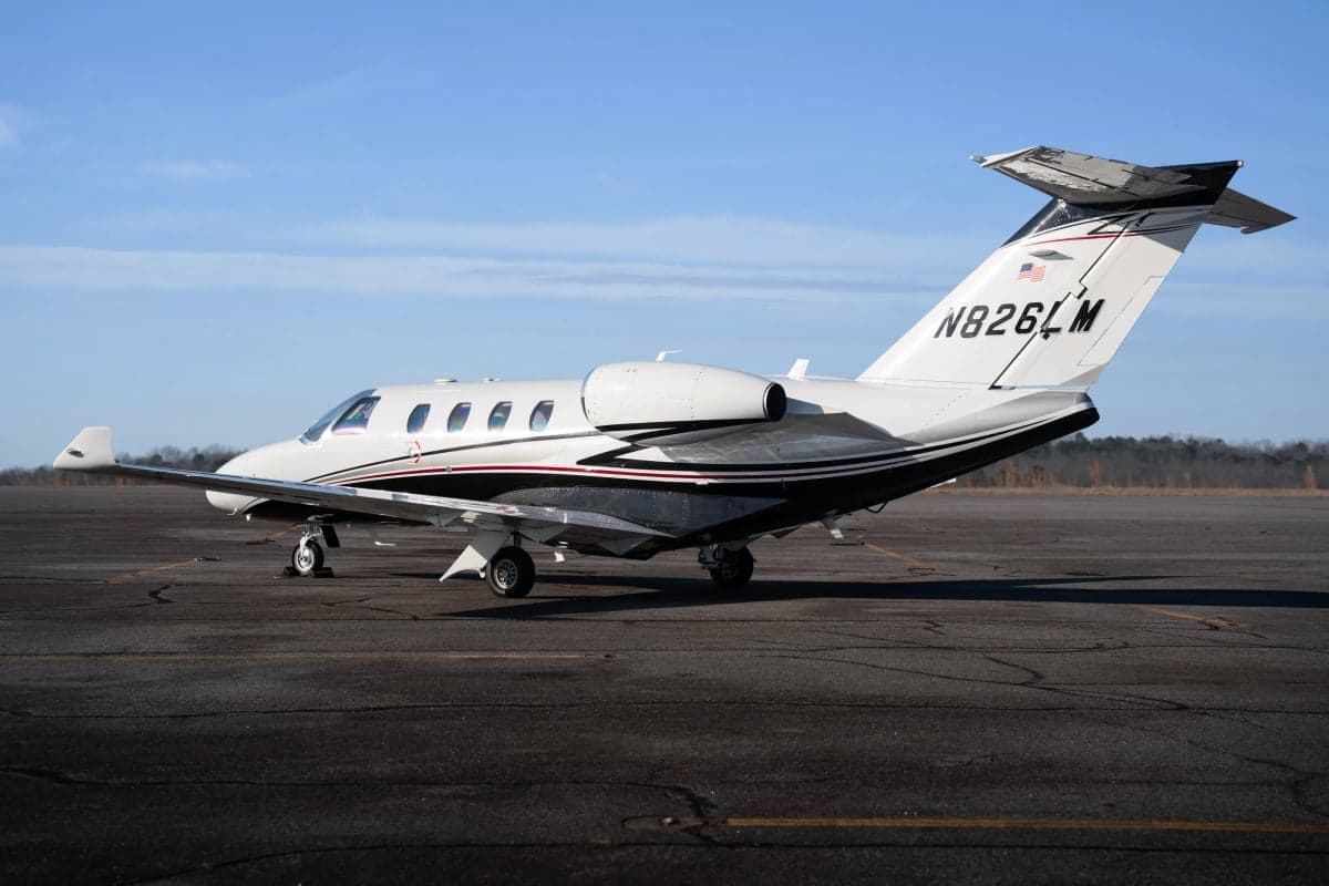 A Cessna Citation CJ3 aircraft is parked on the tarmac, showing its tail number N826LM.